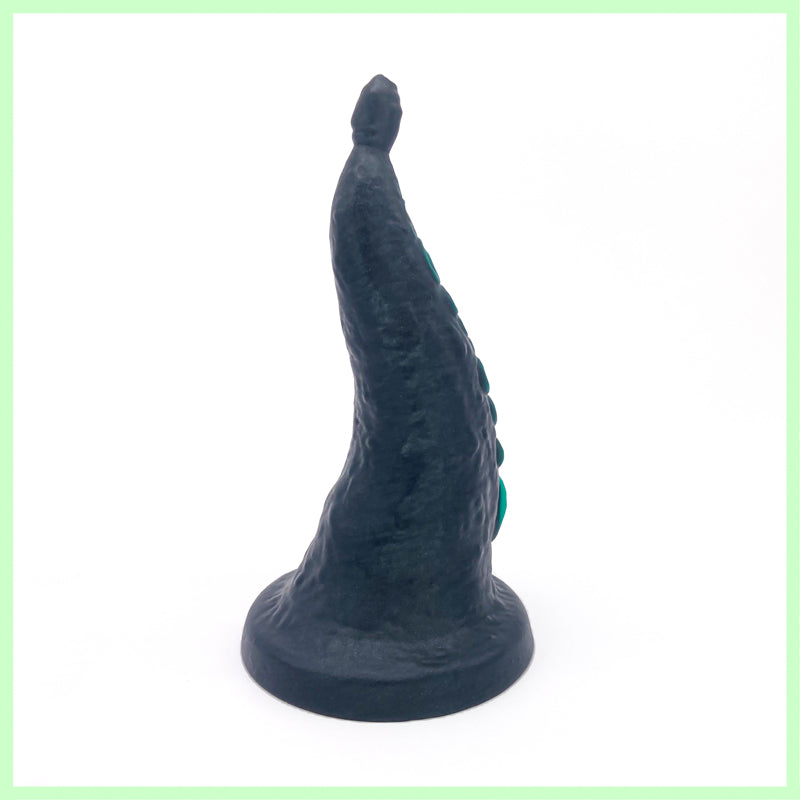 Greb tentacle dildo rear view. Black in colour with green suckers. On a white background