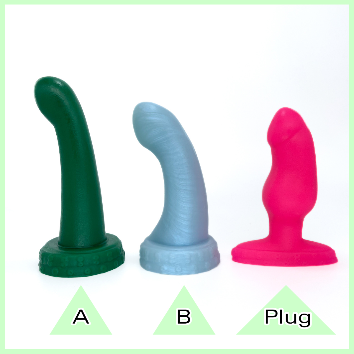 Three Essentickles dildos and plugs in a number of different colours: dark green,  light blue and UV pink