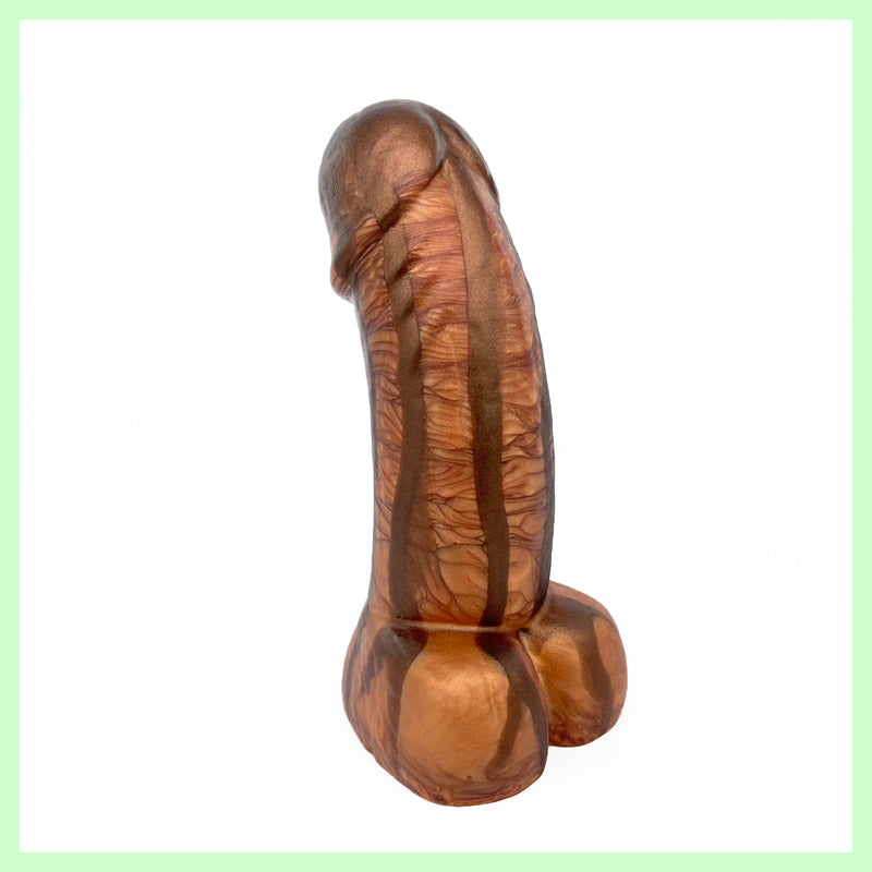 Woodsman dildo front view in brown and bronze with wood grain detail