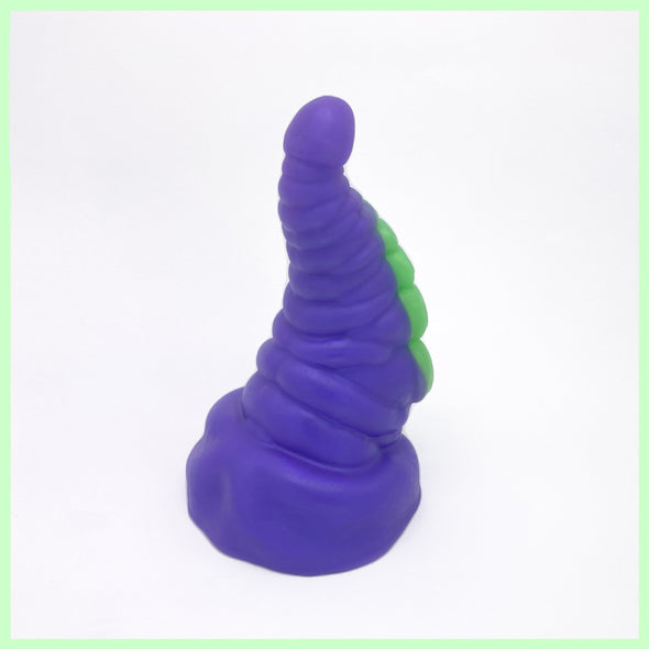 Tentacle tapered dildo rear view in purple with green suckers on a white background